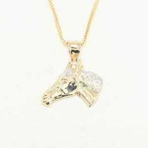 Yellow gold high relief horse head pendant whit white gold main on a yellow gold franco chain.