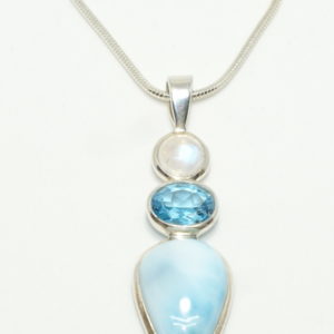 Silver in line pendant with round moonstone oval blue topaz and teardrop shaped larimar on snake chain.