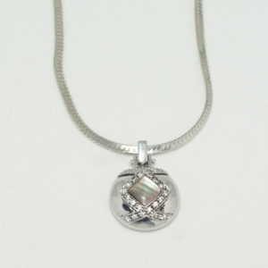 Silver round pendant with black mother of pearl and crystals on herringbone chain.
