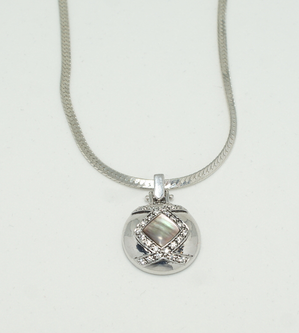 Silver round pendant with black mother of pearl and crystals on herringbone chain.