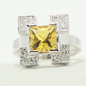 Silver square crystal frame ring with yellow princess gem center ring.