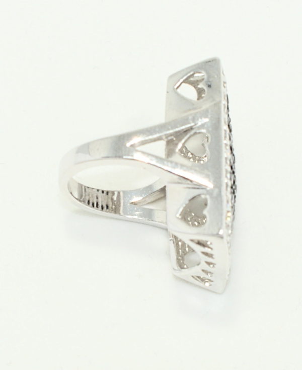 Sideview oversized silver ring with crystals and heart cut out gallery.