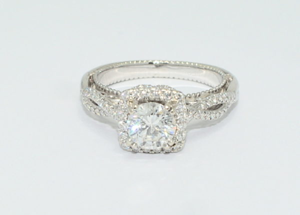 White gold Verragio ribbon engagement ring with round center diamond.