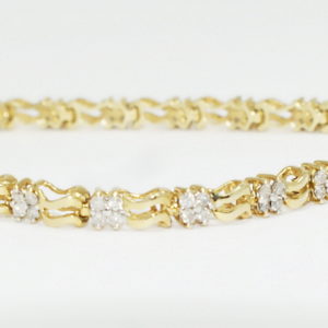 Yelloe gold bracelet with evenly spaced diamond sections.