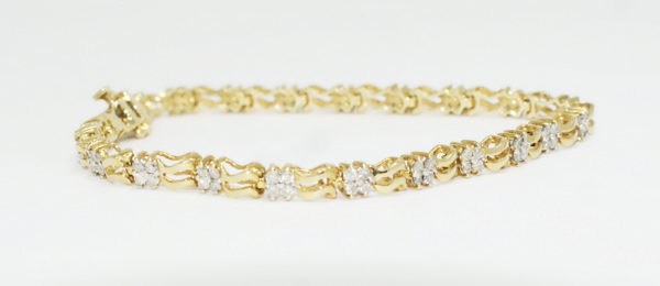 Yelloe gold bracelet with evenly spaced diamond sections.