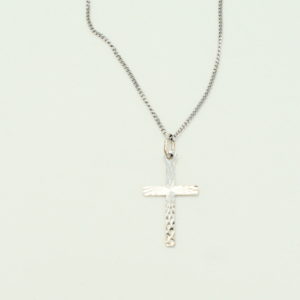 Silver textured cross on curb chain.