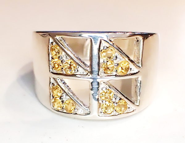 Sterling silver ring with window pane style top and citrine set diagonaly in each pane.