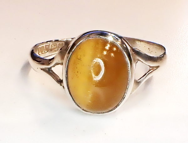 Sterling silver ring with oval cabochon cut tiger;s eye.